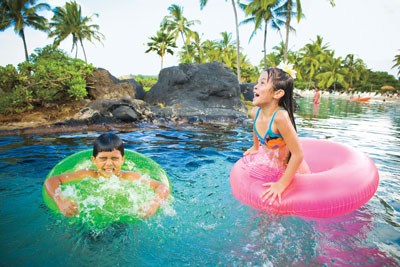 Children play in the Grand Hyatt’s saltwater lagoon. Photo courtesy of Grand Hyatt Kauai Resort and Spa.