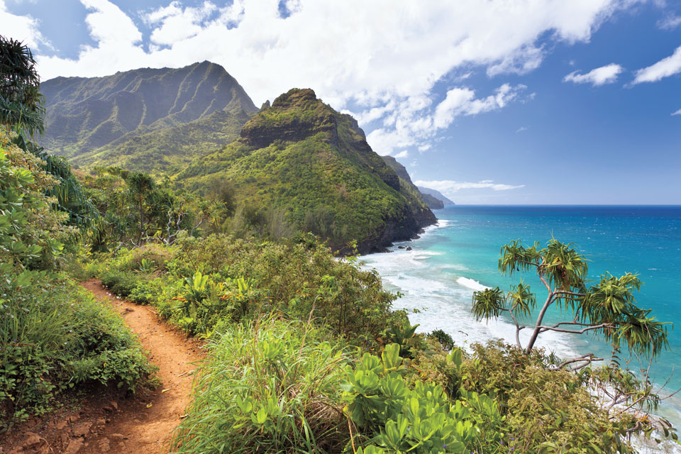 Walk along Kauai’s Kalalau Trail and discover a view of the Na Pali Coast. Shutterstock.