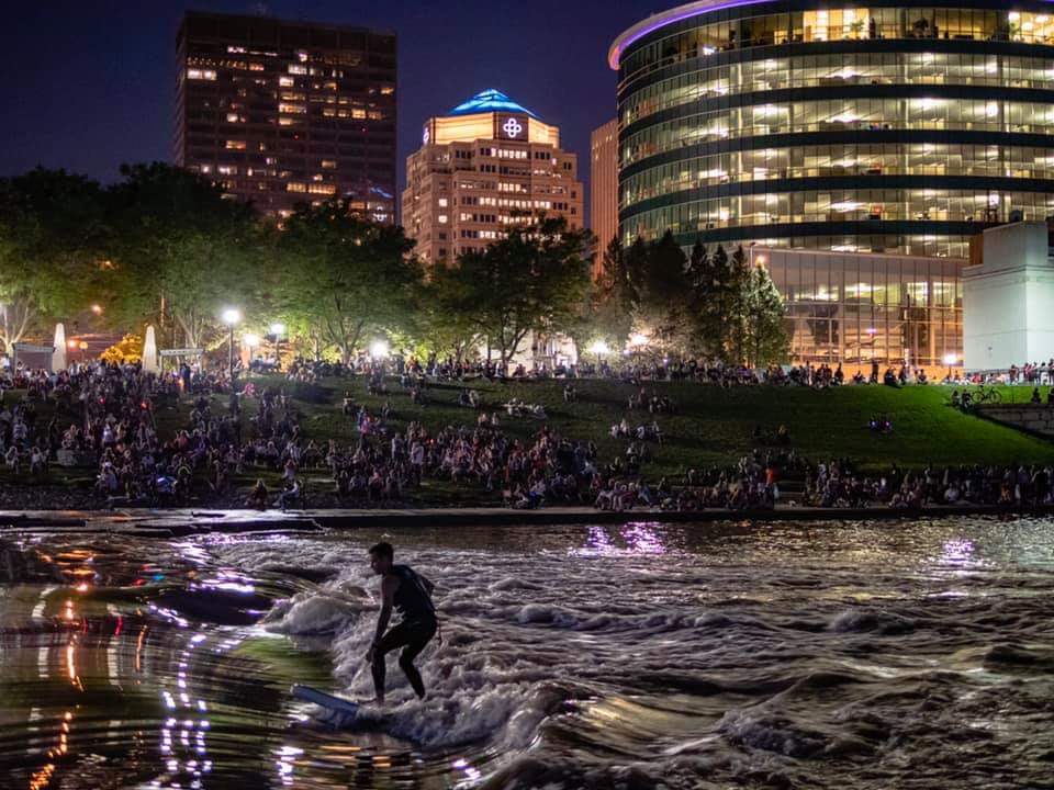 Surf Dayton co-founder Jake Brown river surfing during Fourth of July celebrations in downtown Dayton. Photo - Austin Gordon