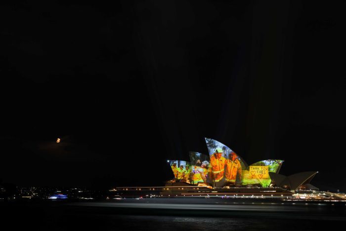 Opera House is lit up with images of firefighters