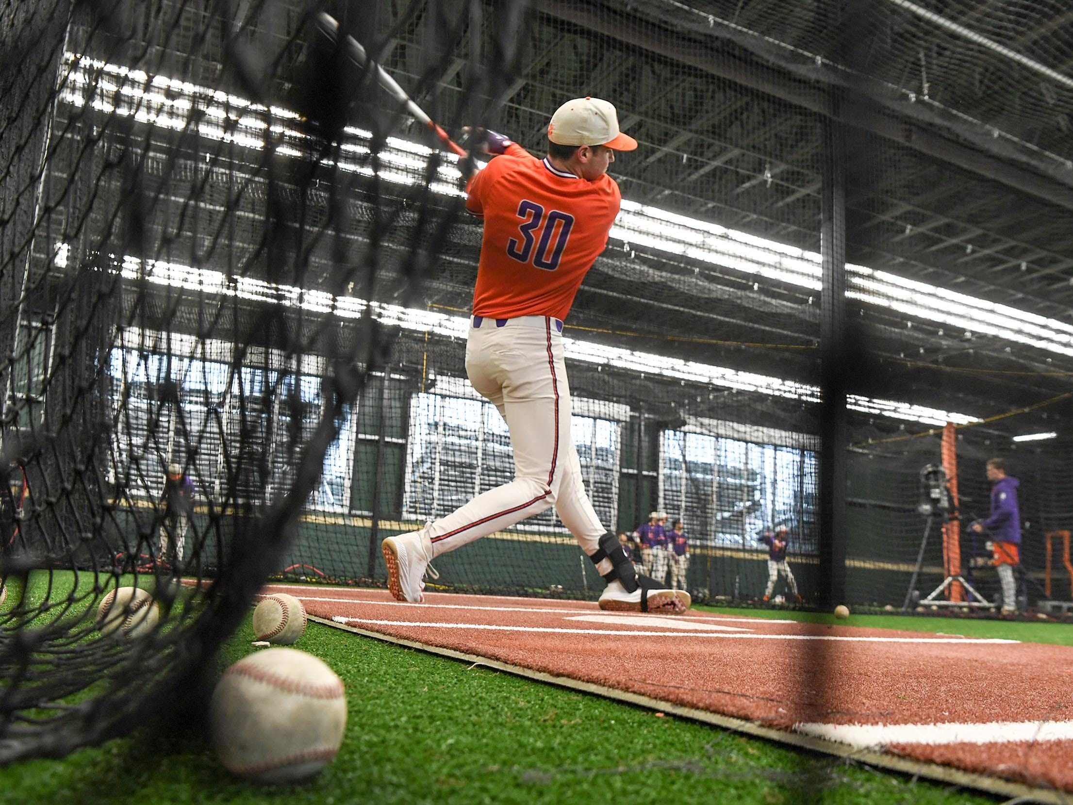 Clemson sophomore pitcher Davis Sharpe (30) swings in the batting cages during the first official team Spring practice at Doug Kingsmore Stadium in Clemson Friday, January 24, 2020.