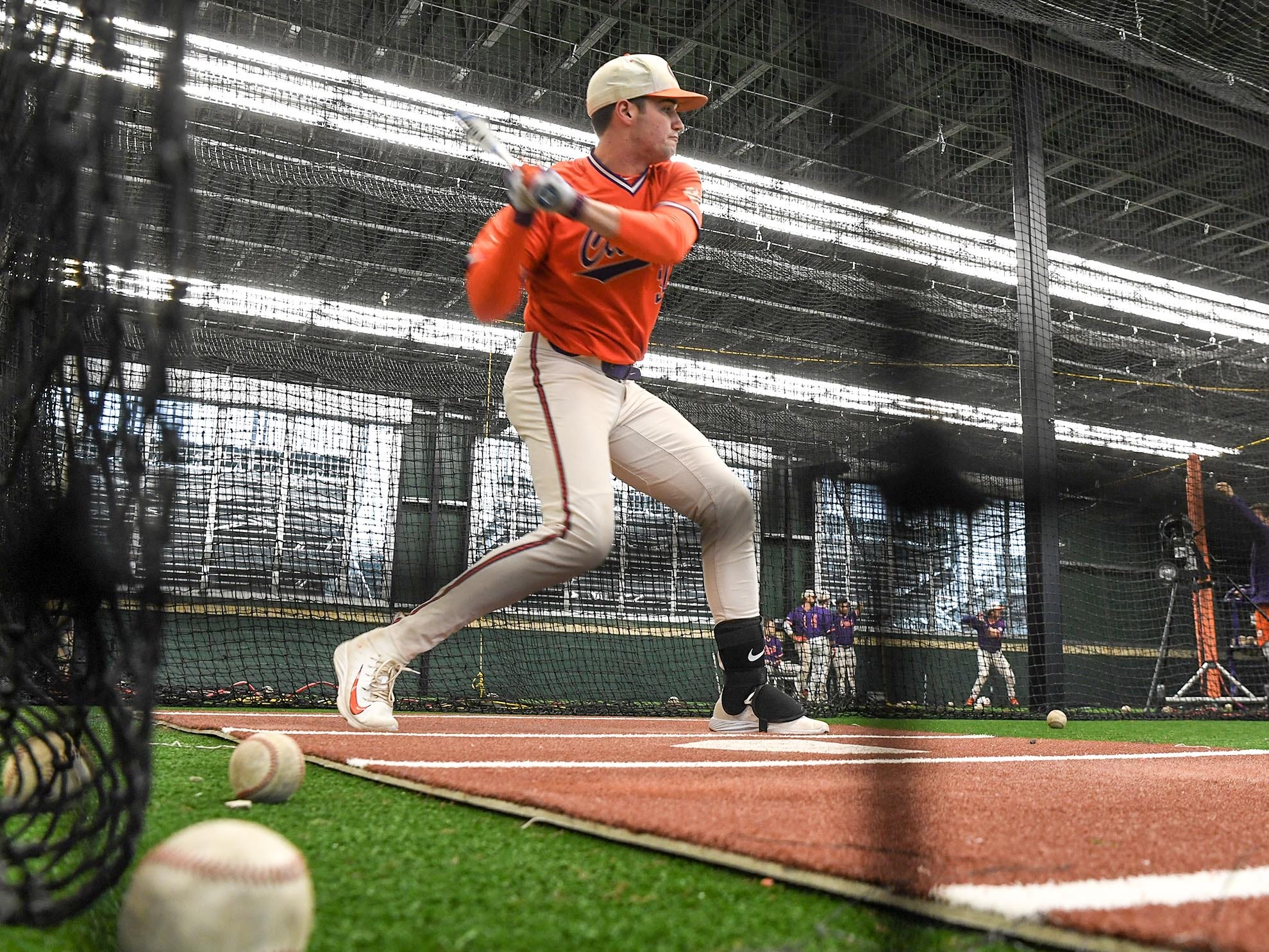 Clemson sophomore pitcher Davis Sharpe (30) swings in the batting cages during the first official team Spring practice at Doug Kingsmore Stadium in Clemson Friday, January 24, 2020.