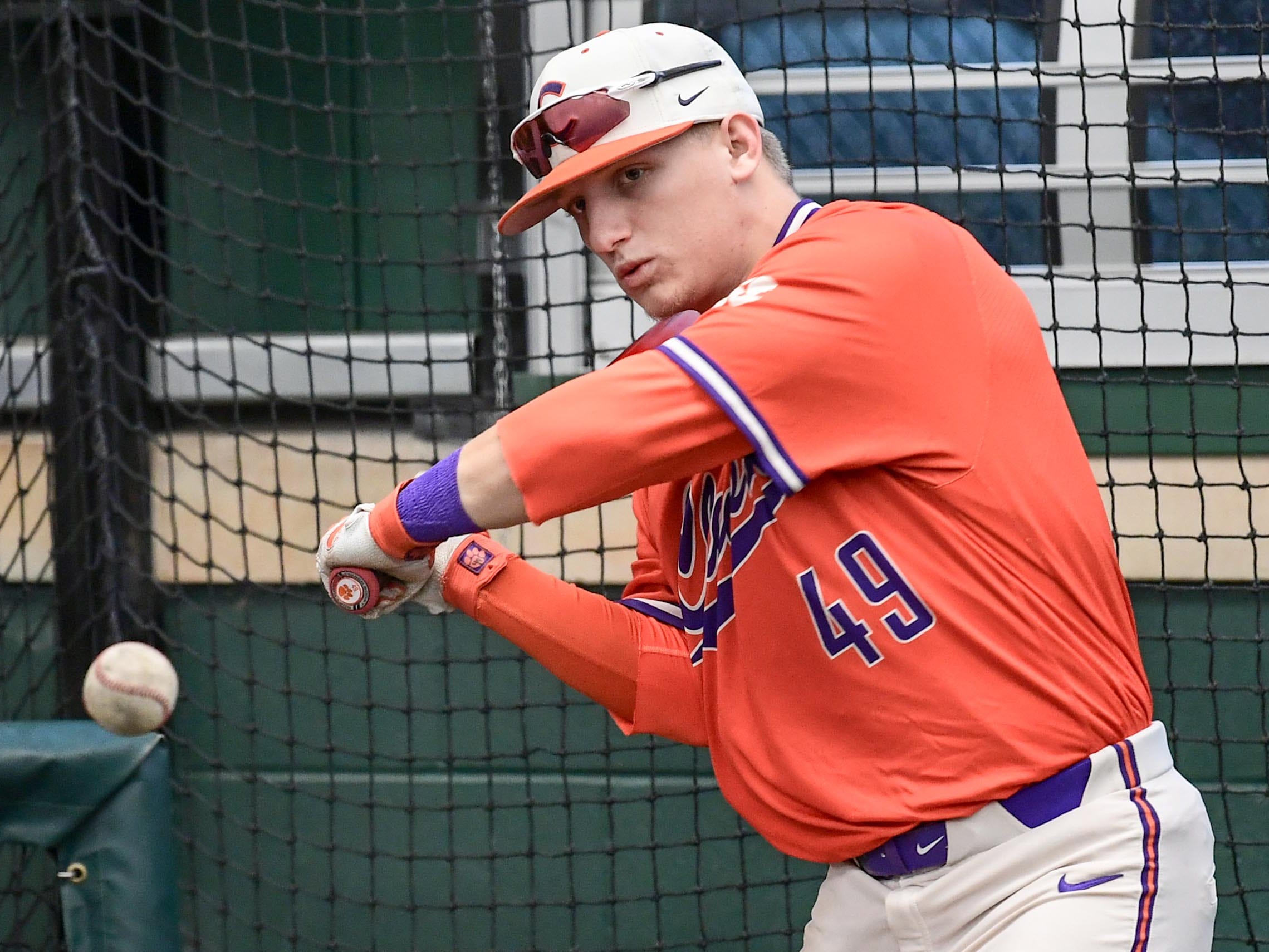 Clemson freshman Regan Reid(49), former T.L. Hanna High standout, swings during the first official team Spring practice at Doug Kingsmore Stadium in Clemson Friday, January 24, 2020.