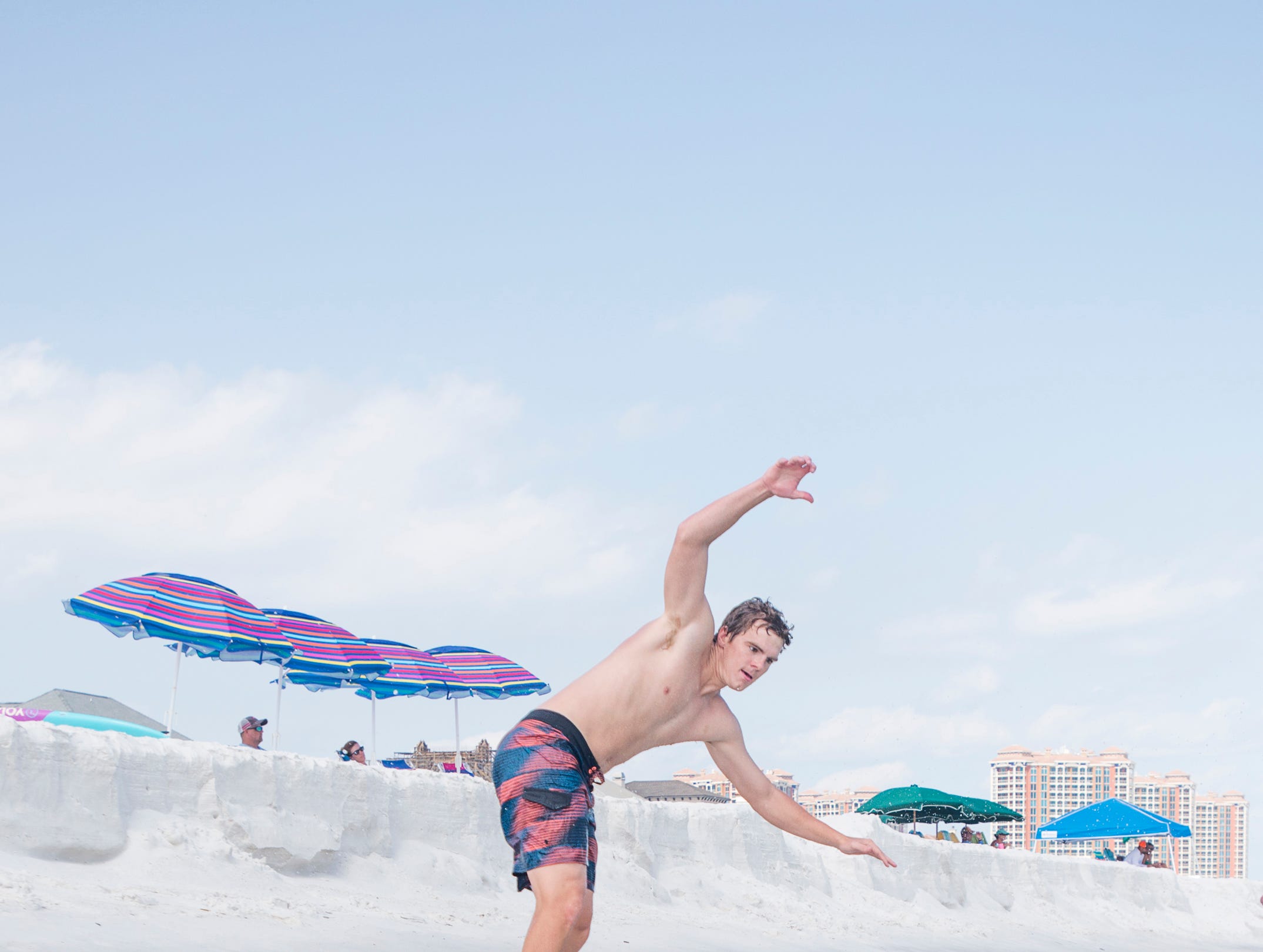 Pensacola News Journal sports reporter Eric Wallace gives skimboarding a try along Penacola Beach on Friday, July 20, 2018.