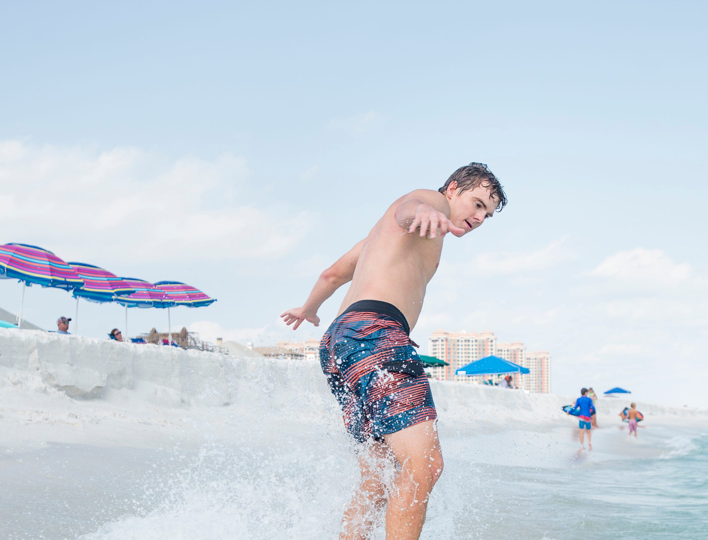 Pensacola News Journal sports reporter Eric Wallace gives skimboarding a try along Penacola Beach on Friday, July 20, 2018.