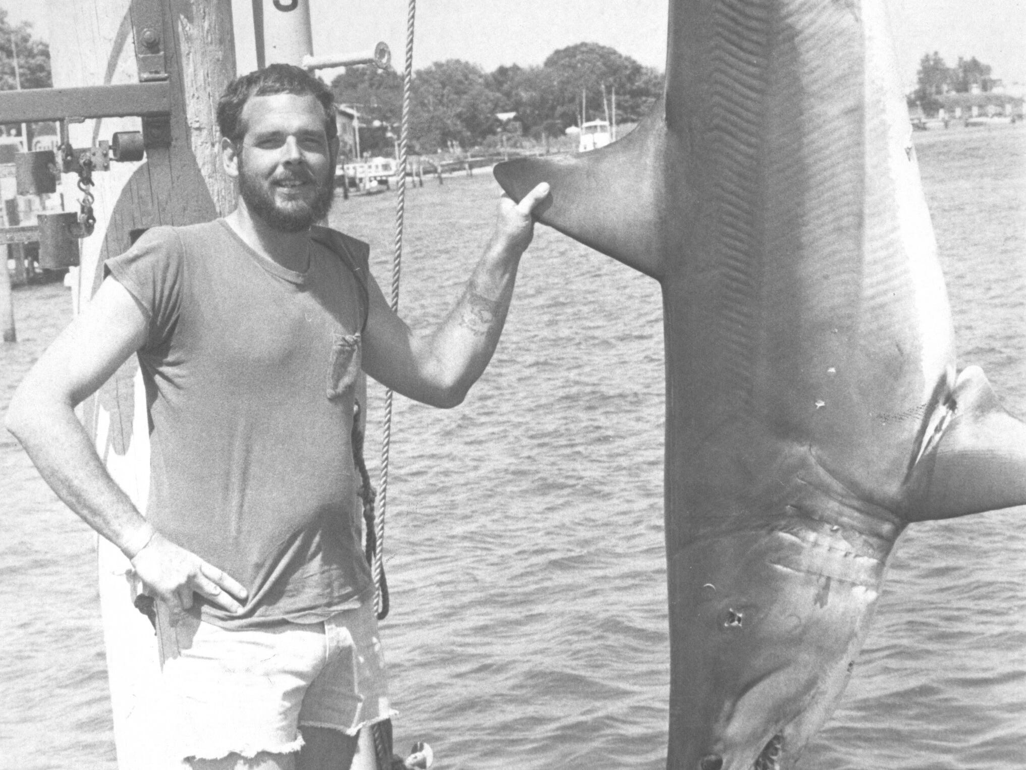 (JULY 11, 1983) This 474-pound mako shark was worth $7,000 to the crew on Ed Springsteen's Scrap Copper. It was the heaviest mako weighed in Hoffman's Anchorage (Brielle) shark tournament. Standing next to the shark is crew member John Troger from Point Pleasant.