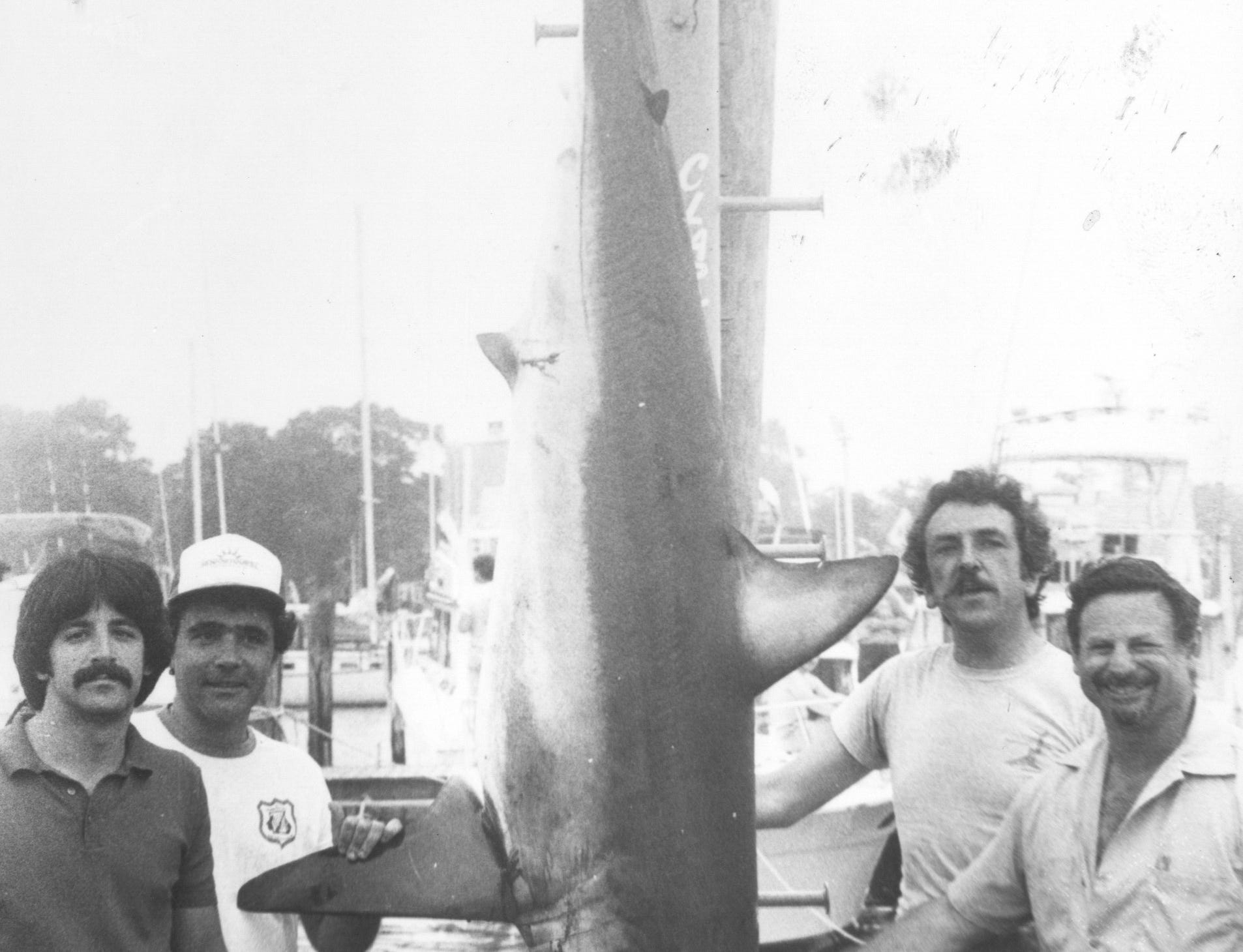 (JUNE 24, 1983) This 311-pound mako shark placed third in the Jersey Coast Shark Anglers annual shark tournament held over the weekend (June 1983). It was caught on the Seaducer II by Al Ristori (right) of Lake Hiawatha. Others, pictured left to right, are: Jim Pappas from Ocean Township; John Thomas from Beachwood; and Capt. Dave Mastrojohn from Point Pleasant. It was worth $2,500 in prize money. o