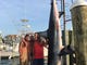 Members of a fishing charter on the Jenny Lee stand with a 926-pound mako shark at Hoffman's Marina in Brielle on July 22, 2017.