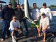 The crew of the Taylor Jean with a 148-pound mako shark as it is weighed in at Hoffman's Marina June 9, 2017.