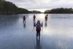 Ice skaters traverse a frozen lake close to Stockholm