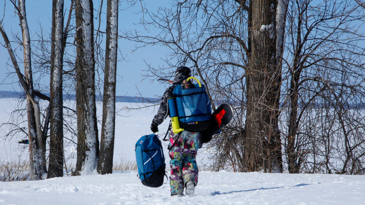 With all of his gear, Campbell walks towards a snow-covered Britannia beach, the spot where he kiteboards.