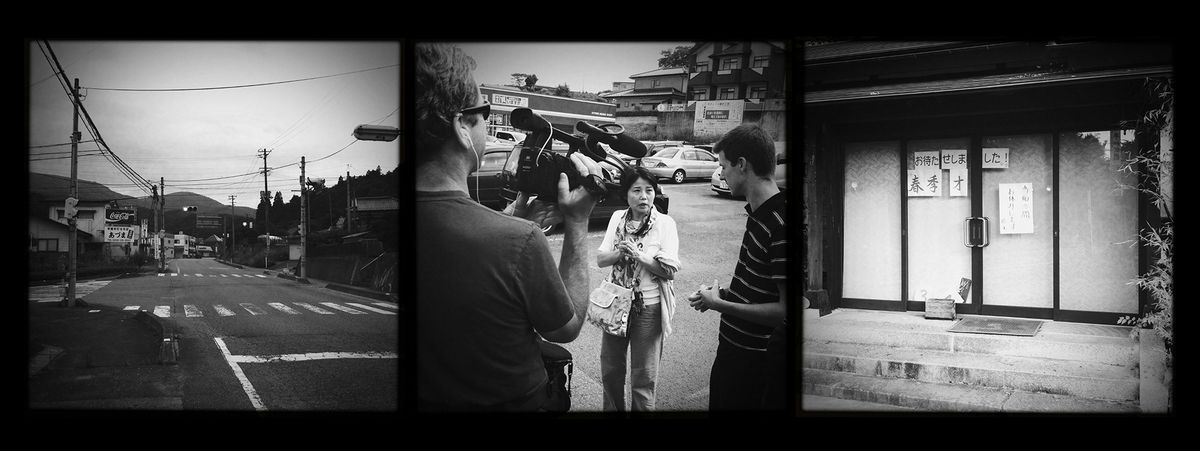 Set of three black and white photos taken in Fukushima following the 2011 tsunami and nuclear disaster. On the left: An empty road. In the middle: A camera crew interviews a woman in a parking lot. On the right, a shutter building.