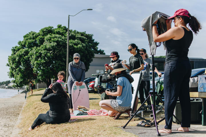 Tima Alhaddad, Lara Khayyat and Aliya Alhaddad with the entire crew filming Tima on Milford Beach.