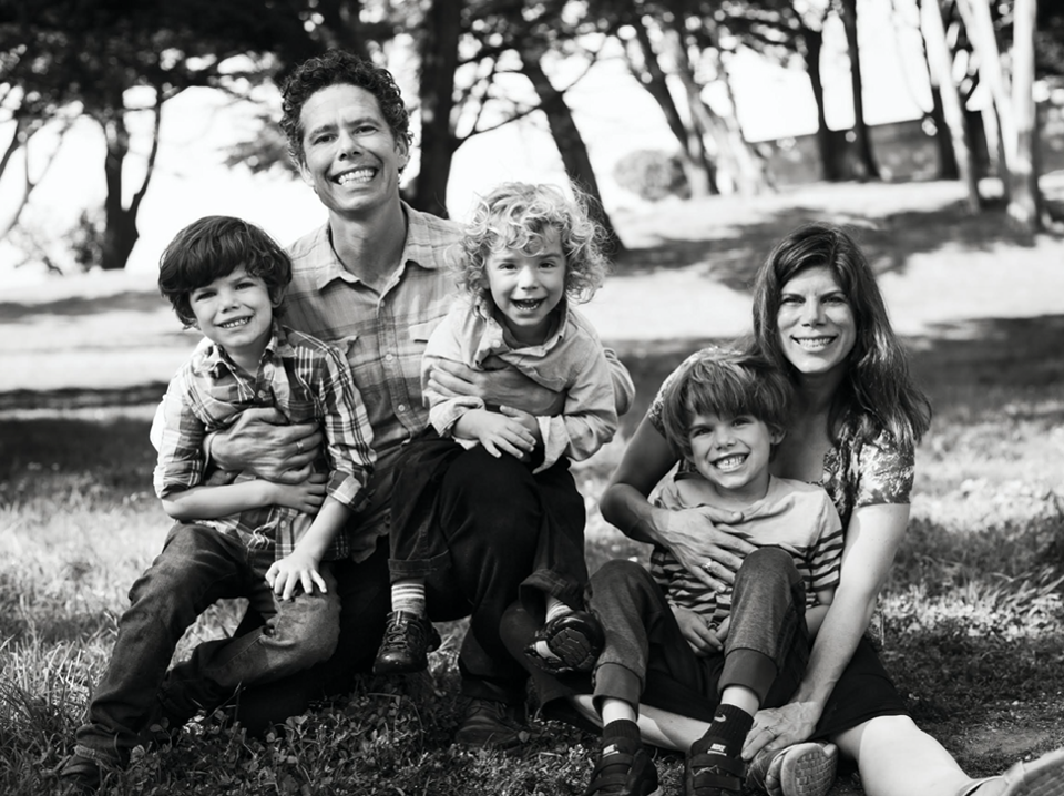 Yogis, wife Amy DuRoss, and three young children pose outside, smiling.