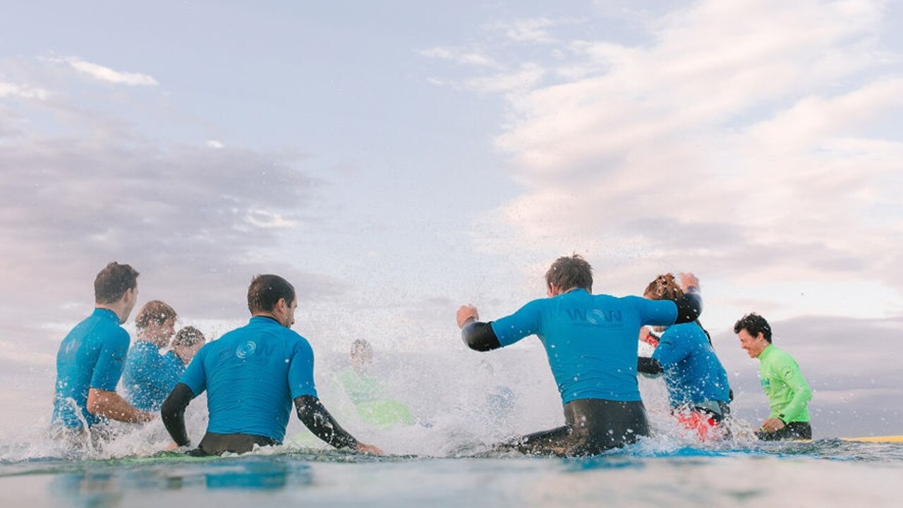 Feeling part of a group learning to surf is the best tonic for these men who are facing life challenges.