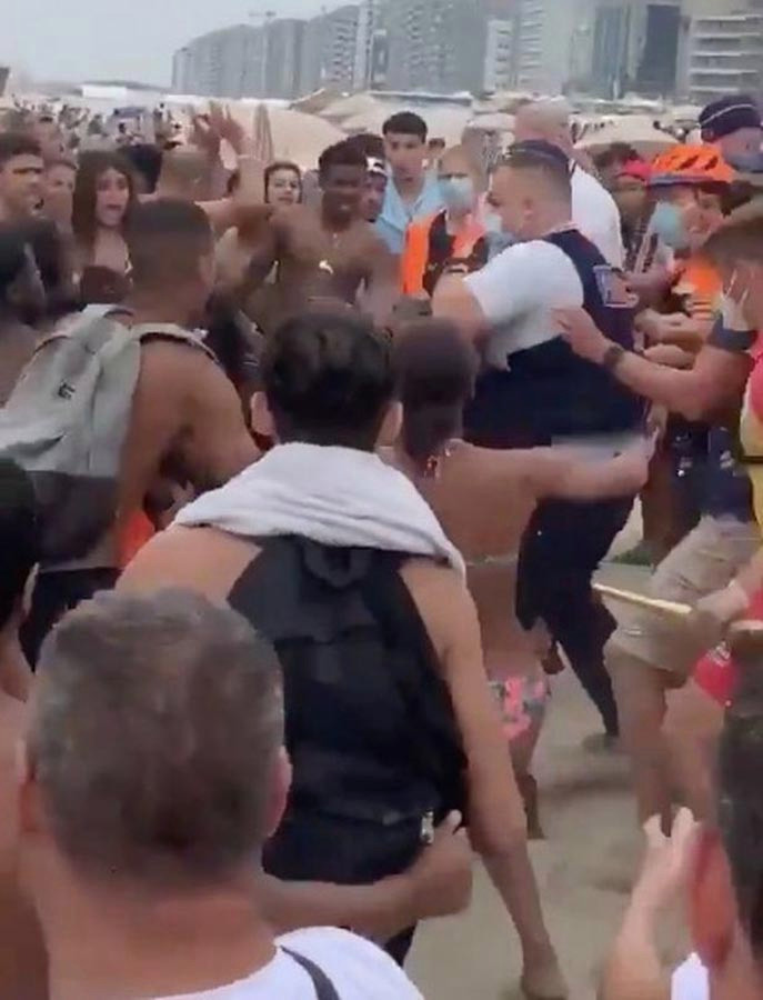 Men and women clash with cops at the beauty spot