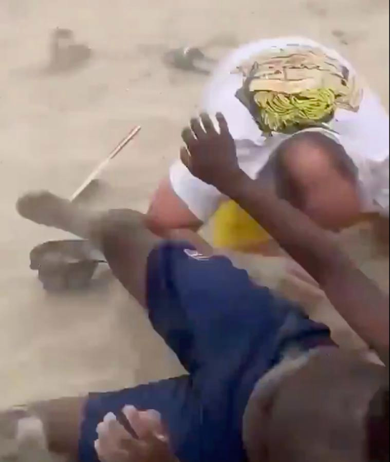 Two men fall to the ground during the brawl