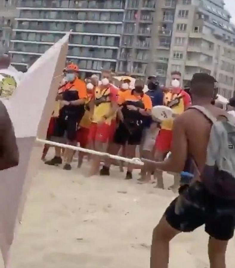One man tried to use the umbrella as a weapon, throwing it at a police officer as lifeguards watched on