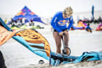 Contestant blows up kite for kitesurfing competition.