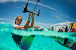 Kitesurfer Susanne Mai pauses in the water for a photo.