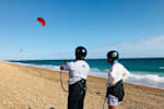 A kitesurfing instructor teaches a lesson.