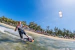 Ruben Lenten riding by the camera and making a peace sign in Le Morne, Mauritius.