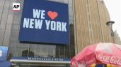 a sign on the side of a building: NYC greeting travelers with quarantine reminder