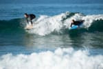 Sam surfs with her son, Noah, at Bilgola.