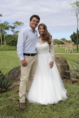 Bindi Irwin standing in the grass: Just married! The young couple were married on March 25, in a makeshift ceremony at Australia Zoo, just before Covid pandemic lockdown