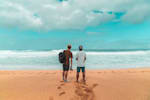 Andy Burgess and Hugo Pinheiro survey the surf at Pipeline on the North Shore of Hawaii.