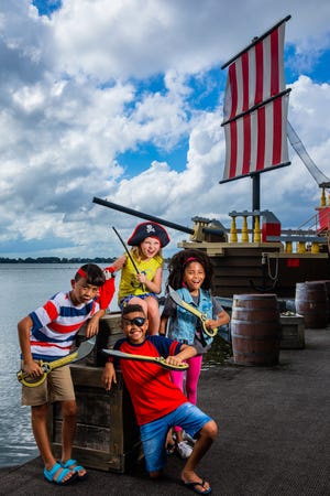 Young guests pose at the site of the Brickbeard's Bounty ski show on Lake Eloise at Legoland Florida Resort. Legoland announced plans for a new watersports show that will introduce a female Pirate character.