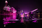 An image of wakeboarder Meagan Ethell in the water at Boathouse Row, Philadelphia with a pink backdrop behind.
