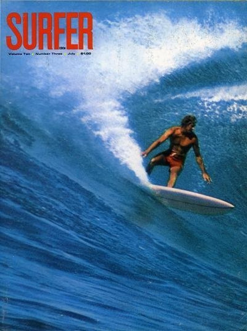 A surfer rides a wave on the cover of an issue of Surfer magazine